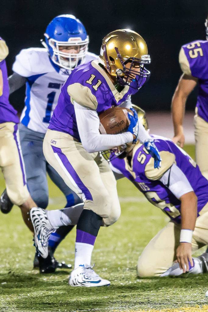 Aaron Martinez picks up some yards for Oak Harbor.(Photo by John Fisken)