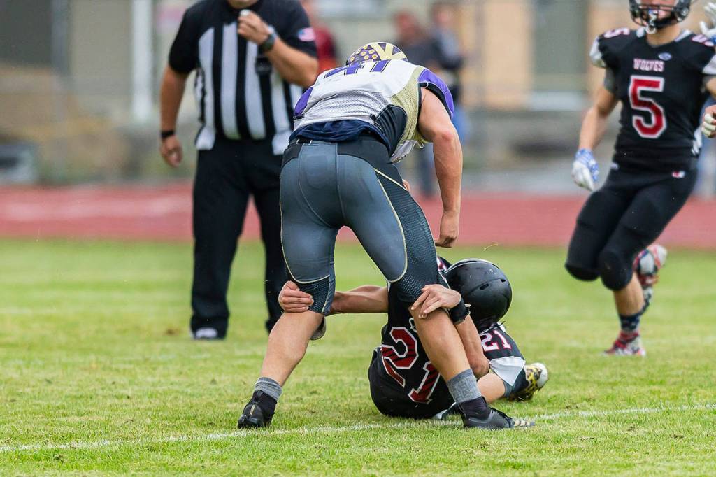 Sean Toomey-Stout snags a Friday Harbor ball carrier.(Photo by John Fisken)