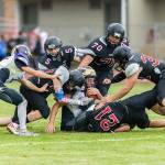 A pack of Wolves smother a Friday Harbor ball carrier in Fridays game at Mickey Clark Field.(Photo by John Fisken)