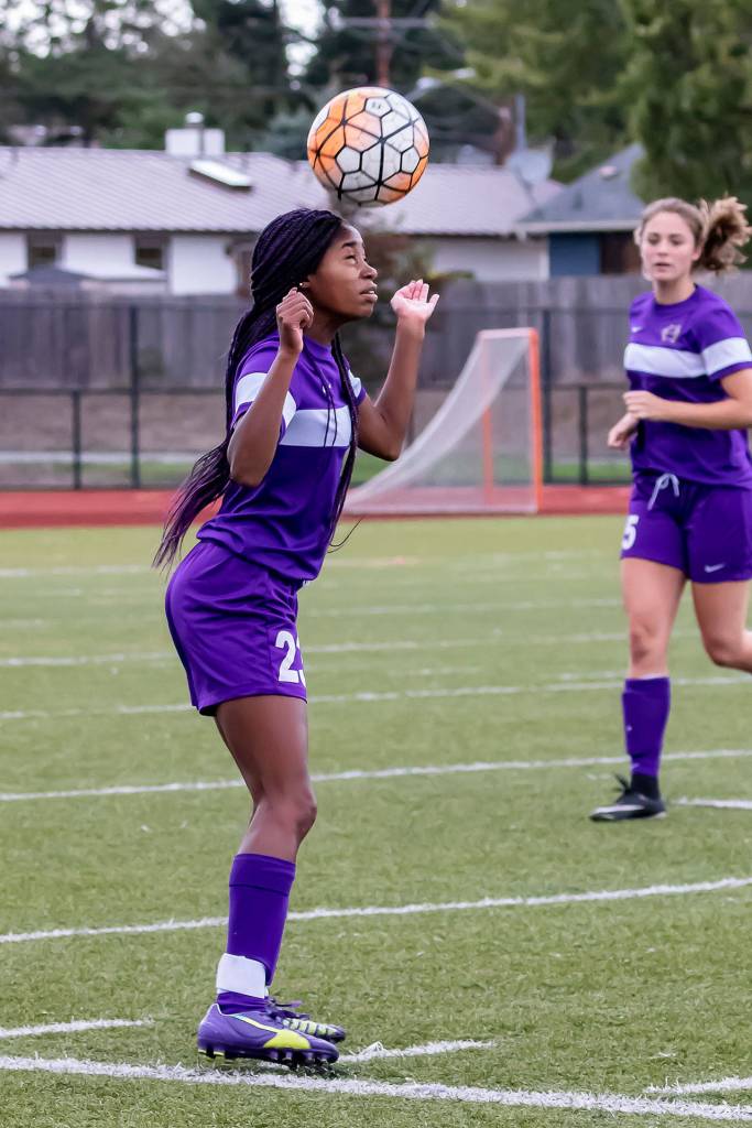 Jessica Vester uses her head to control the ball for the Wildcats.(Photo by John Fisken)