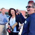 Mel Watson, of Island Senior Resources, shows off the key to the first van used in Island Transits RideLink program for nonprofits. Island Transit Executive Director Mike Nortier and Julie Lloyd, who coordinates the program, look on. Photo by Laura Guido/Whidbey News Group
