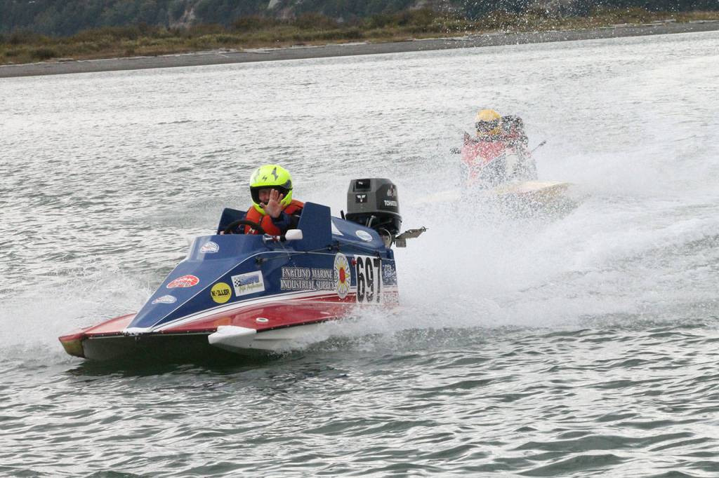 A hydroplane driver returns the pits, waving to the crowd on his way in Sunday..                                Photo by Jim Waller/Whidbey News-Times