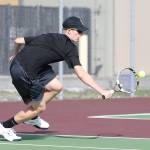 Jakobi Baumann runs down a shot in first singles in the Wolves match with Bear Creek.(Photo by John Fisken)