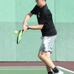 Jacob Burke returns a shot in first doubles.(Photo by John Fisken)