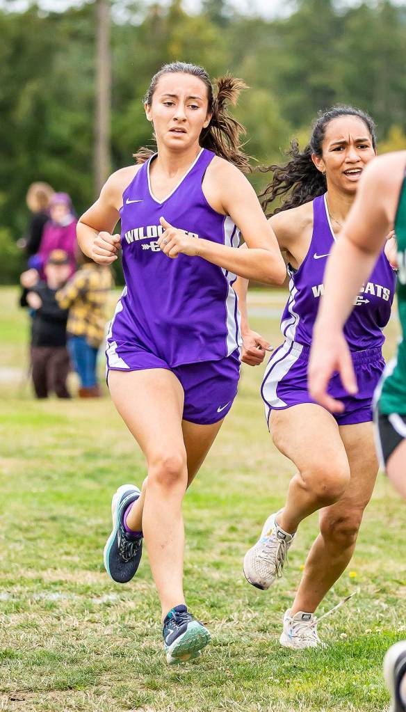 Evelyn Osburn, left, and Stephanie Flores were the third and fourth Oak Harbor female runners to finish.(Photo by John Fisken)