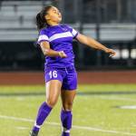 Tiana Jackson heads the ball for Oak Harbor. (Photo by John Fisken)