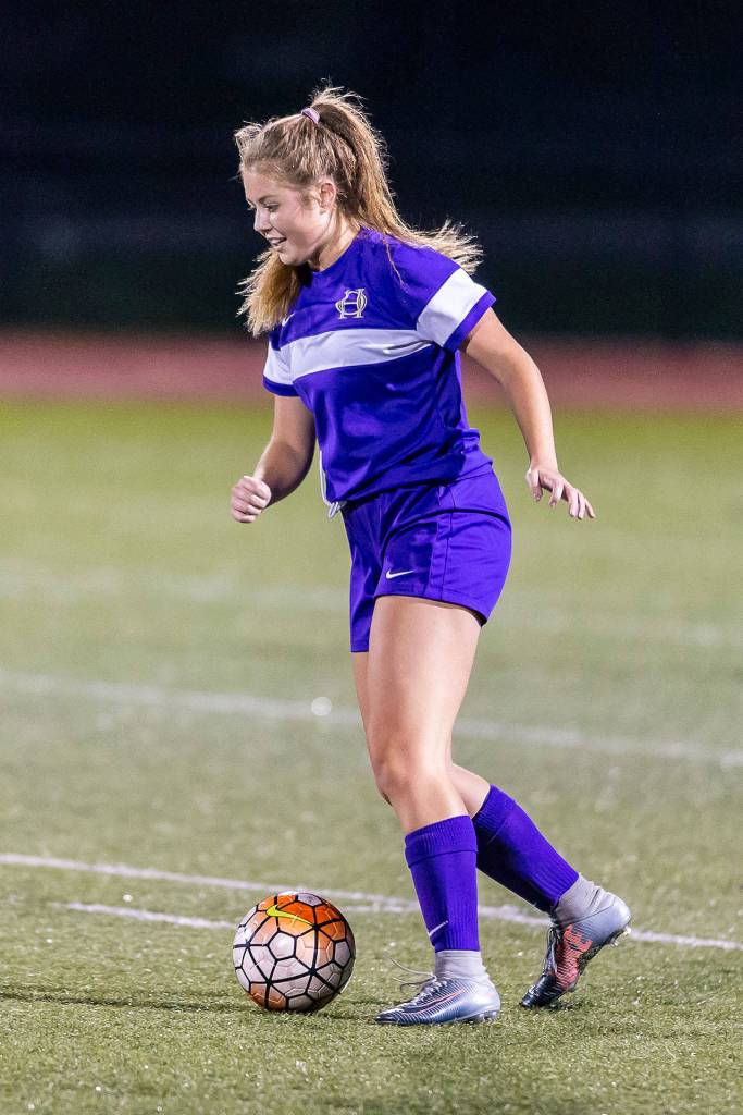 Natalie Plush pushes the ball up field for Oak Harbor.(Photo by John Fisken)