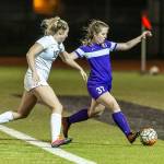 Oak Harbors Peyton Rhyne beats Edmonds-Woodways Meghan Ashe to the ball.(Photo by John Fisken)