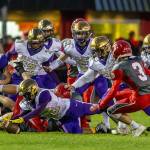 Oak Harbors Ethen Decherong recovers a fumble as a sea of teammates closes in.(Photo by John Fisken)