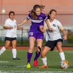 Oak Harbors Danielle Lonborg (10) battles a Getchell player for possession.(Photo by John Fisken)