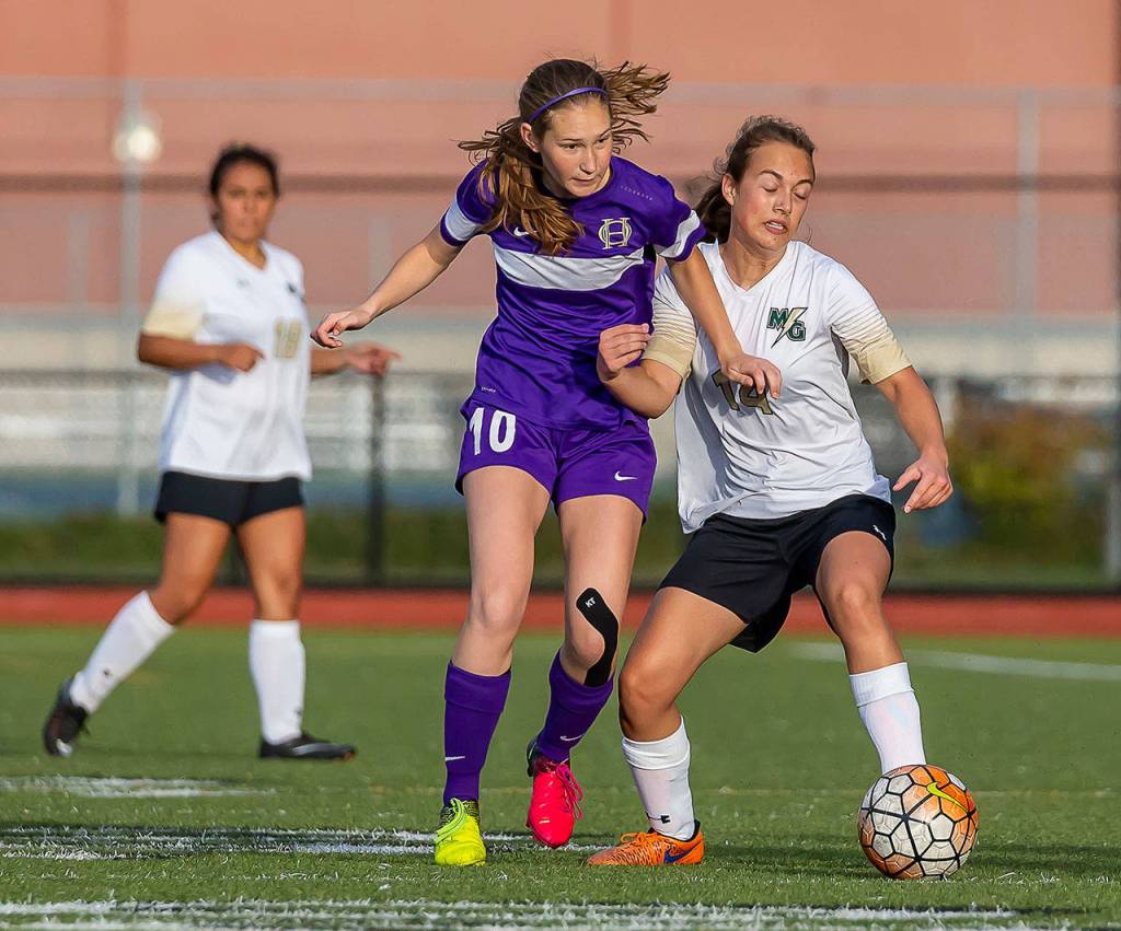 Oak Harbors Danielle Lonborg (10) battles a Getchell player for possession.(Photo by John Fisken)