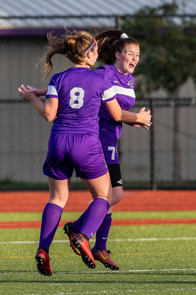 Peyton Rhyne (8) celebrates with Gracie Hiteshew after Hiteshews goal give Oak Harbor the lead.(Photo by John Fisken)