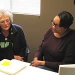 Photo by Dave Felice                                <em>Maureen MacDonald (left) of the Genealogical Society of South Whidbey Island looks at documents with Island County Historical Society archivist Cassie Rittierodt.</em>