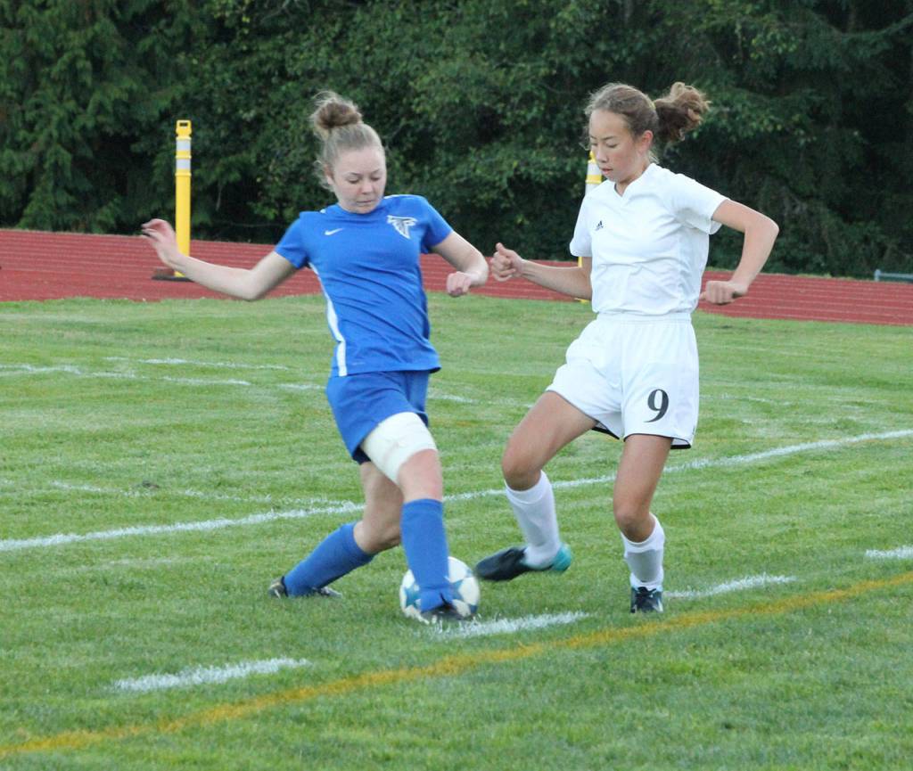 Coupevilles Mary Milnes (9) battles Mallory Drye for possession.(Photo by Jim Waller/Whidbey News-Times)