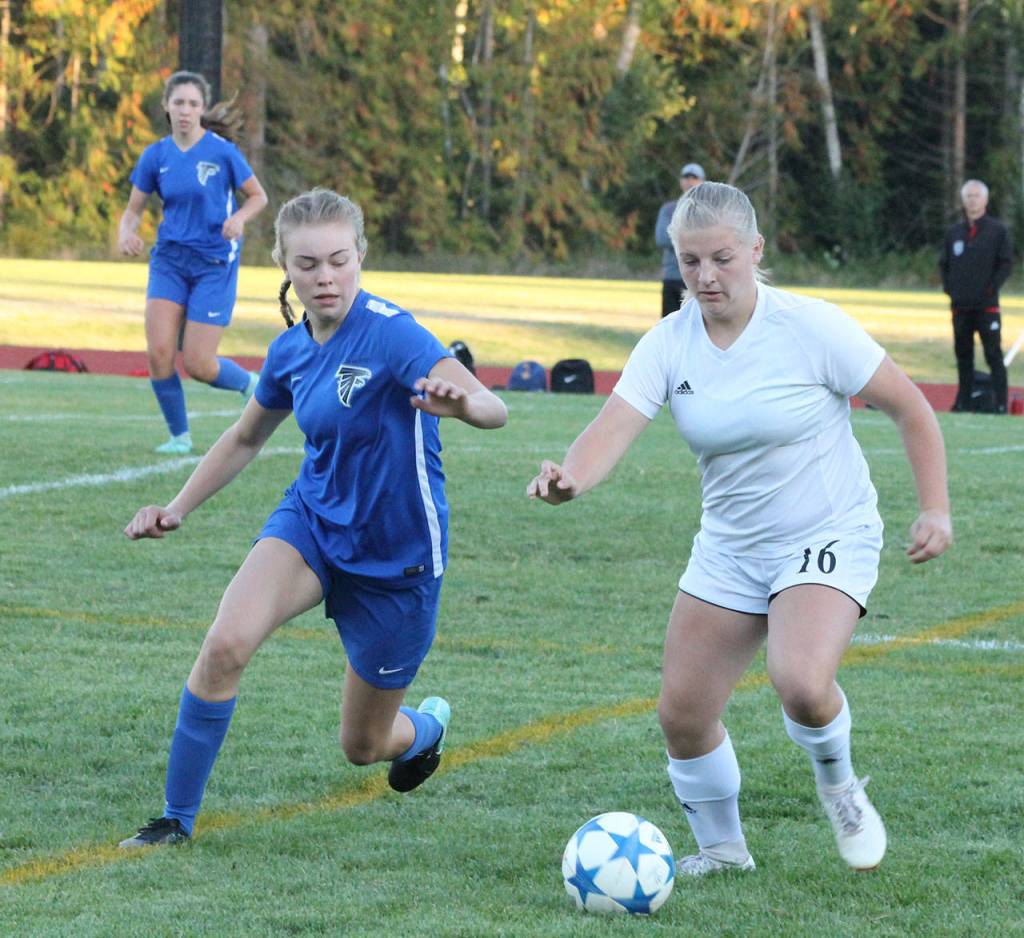 Coupevilles Avalon Renninger (16) and South Whidbeys Julian Larson close in on the ball.(Photo by Jim Waller/Whidbey News-Times)