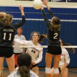Emma Smith, center, watches her hit split the block of South Whidbeys Emma Hodson (11) and Alyssa Ludtke (2).(Photo by Jim Waller/Whidbey News-Times)