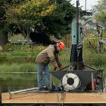 Photo by Maria Matson / Whidbey News-Times                                Mike Brown runs the machine that is extracting goose and duck poop from the bottom of the Greenbank Farm pond.