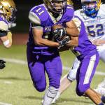Aaron Martinez receives a handoff from QB Caleb Fitzgerald.(Photo by John Fisken)