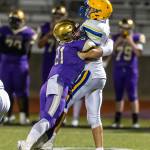 Oak Harbors Calvin Whelpley (21) hits Ferndale quarterback Sequoyah Julius.(Photo by John Fisken)