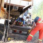 Ryan Walker and Cody Robertson stack beams to prop up the Quonset hut that members of the PBY Memorial Foundation are trying to save. Photo by Laura Guido/Whidbey News-Times