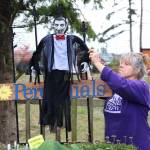 Jackie Bartsch of Rain Shadow Nursery hangs a vampire in front of her perennials. Photos by Laura Guido/ Whidbey News Group
