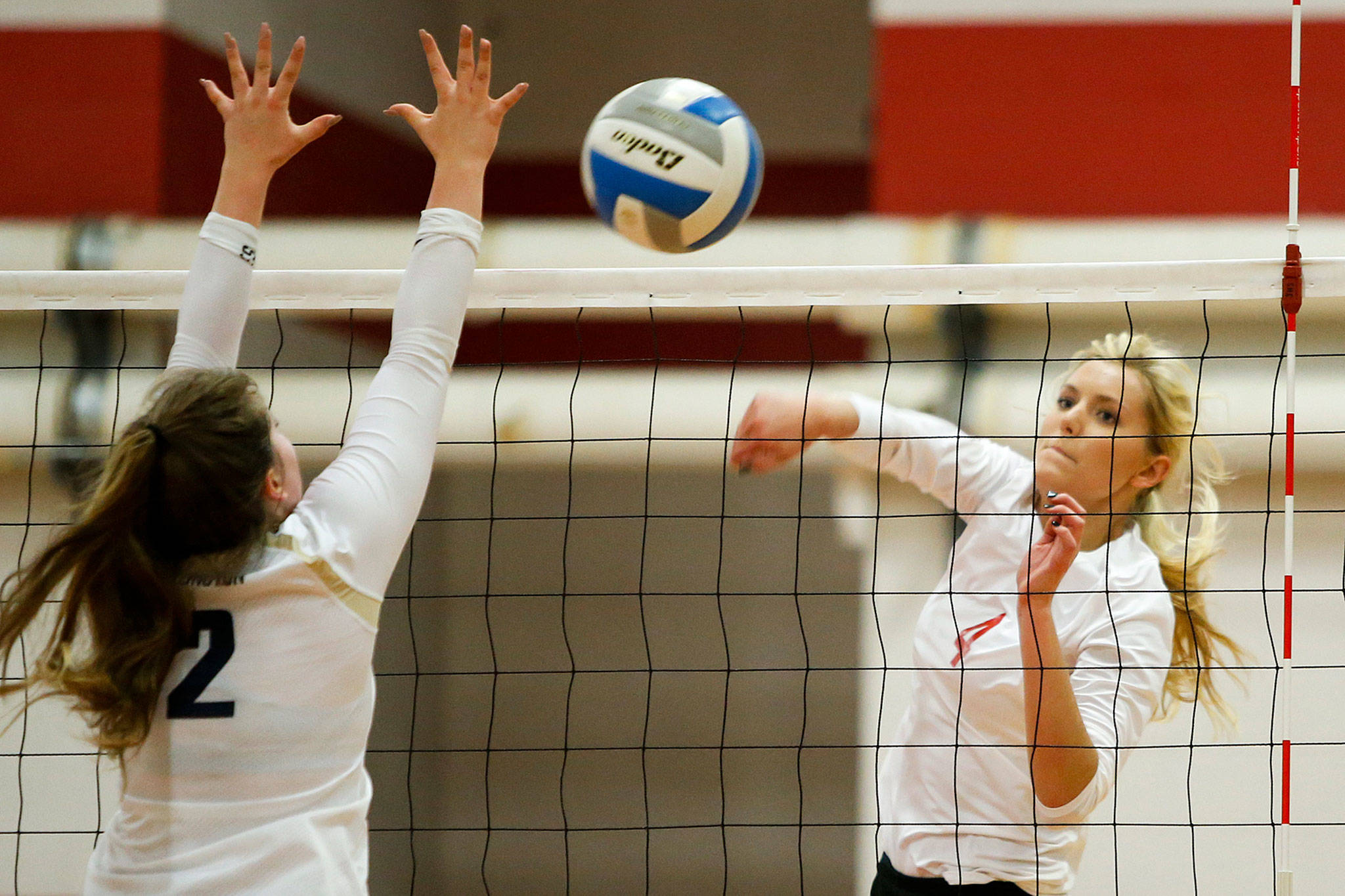 Stanwoods Devon Martinka, right, and her Stanwood teammates invade Oak Harbor Thursday. (Photo by Ian Terry/Everett Herald)