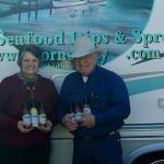 Photo by Maria Matson/Whidbey News Group.                                <em>Cornet Bay Company owners Arnie and Joanne Deckwa stand with their new seafood line of sauces. In the background, painted on their RV is the companys logo depicting Cornet Bay, the view across from their office.</em>
