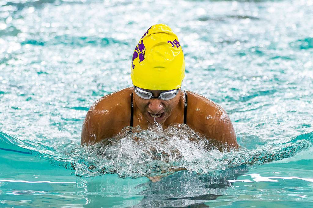Diandra Dominguez competes for an Oak Harbor relay team Tuesday. (Photo by John Fisken)
