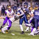 Bennett Anderson (20) and Brenden Andersen (26) tackle an Arlington ball carrier as Jake Mitten (32), Anthony Reyes (42), William Dylander (9) and Cody Fenton (6) close in.(Photo by John Fisken)