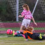 Anna Dion punches in a goal for Coupeville. (Photo by John Fisken)