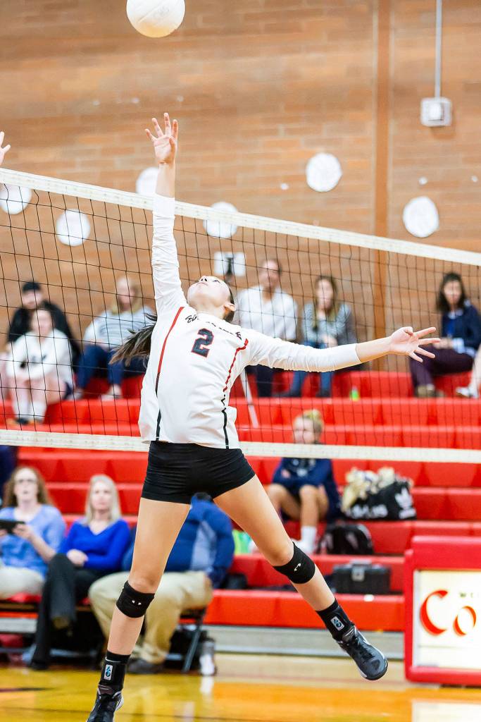Scout Smith tips a high pass over the net.(Photo by John Fisken)