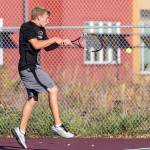 Drake Borden shoots a backhand in Mondays match. (Photo by John Fisken)