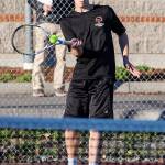 Tiger Johnson returns a shot on the way to winning the third doubles match.(Photo by John Fisken)