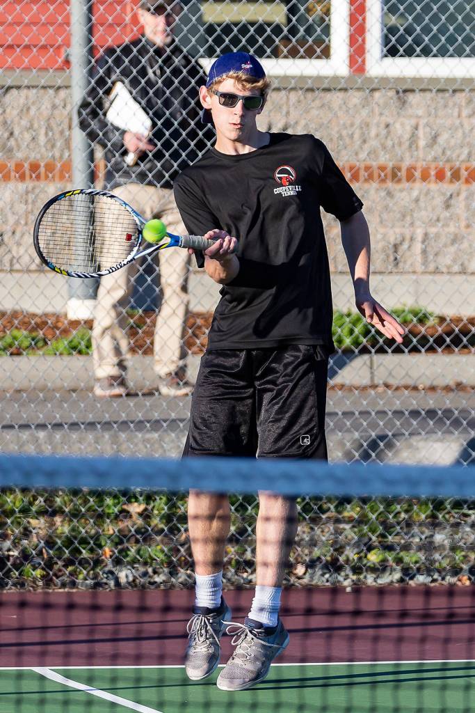 Tiger Johnson returns a shot on the way to winning the third doubles match.(Photo by John Fisken)