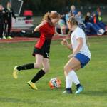 Coupevilles Anna Dion, left, tries to set up a cross. (Photo by Jim Waller/Whidbey News-Times)