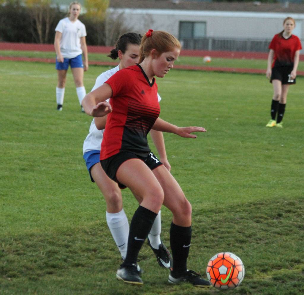 The Wolves Ema Smith shields Alison Papritz from the ball.(Photo by Jim Waller/Whidbey News-Times)