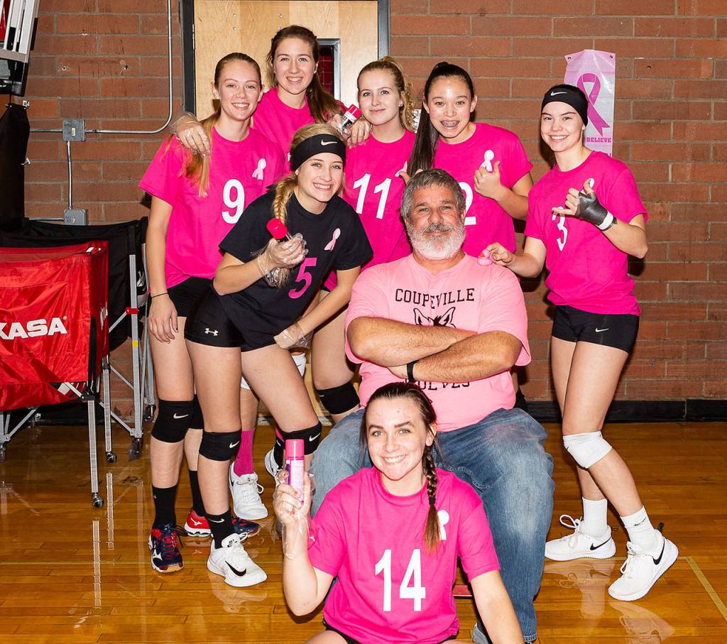 Each year before the Wolves Dig for the Cure match, the players pink-up John Fisken. (Photo by Diane Fisken)