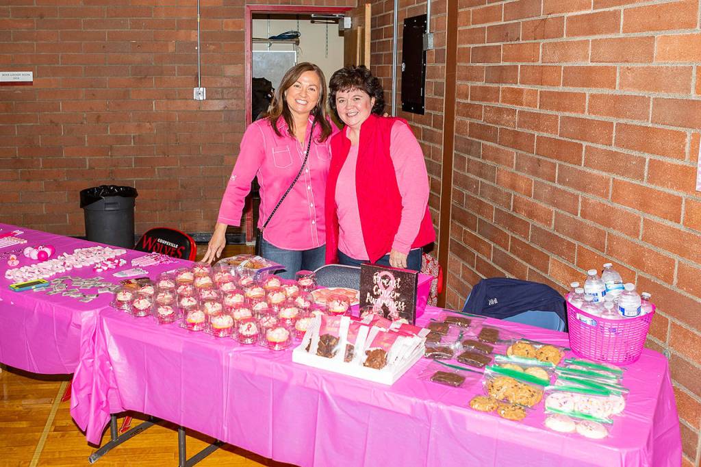 Irene Echenique, left, Renae Mulholland manage the fundraising table at Dig for the Cure Night. (Photo by Diane Fisken)