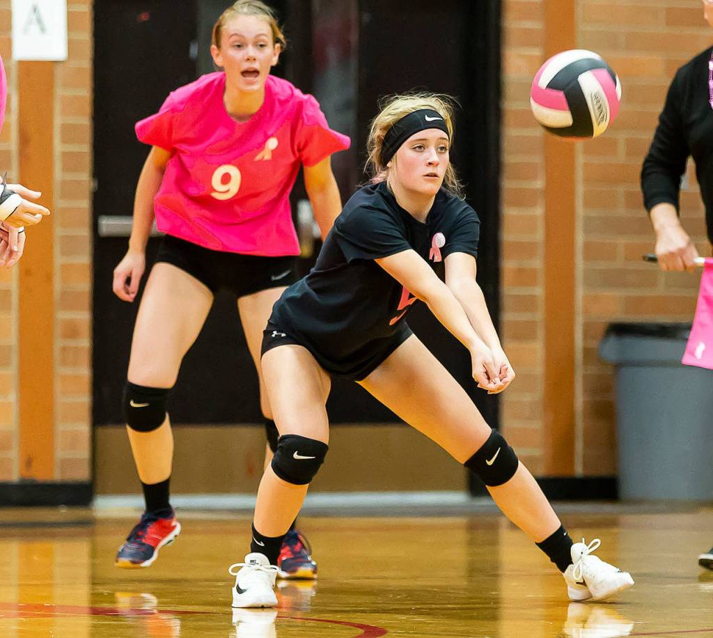 Emma Mathusek passes for the Wolves as Chelsea Prescott, back, gives instructions.(Photo by John Fisken)