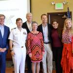 From left, Burr Ault, Capt. Matt Arny, William B. Ault II, Margaret Ault, William R. Ault, Anna Ault and Clara Agnes Ault stand after a ceremony to commemorate the 75th anniversary of the naming of the Ault Field after William Bowen Ault. Photo by Laura Guido/Whibey News-Times