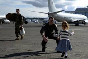 Navy photo                                Lt.Cmdr. John Bartis, a pilot assigned to the Skinny Dragons of Patrol Squadron, reunites with his daughter following a seven-month deployment in the U.S. 7th Fleet area of responsibility. VP-4 returned to Whidbey last Thursday. Story on page A6.