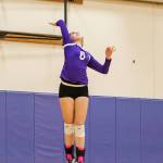 Payton Parks leaps to serve in the Wildcat win.(Photo by John Fisken)