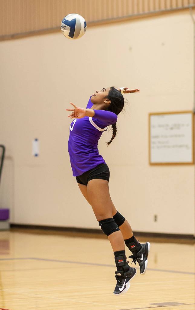 Jaslin Webster serves in the Wildcats big win Thursday.(Photo by John Fisken)