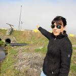 Jaime Jensen, base environmental water program manager, points to a creek that flows off base in which toxic firefighting foam chemicals were found. The source of the contamination is under investigation. Photo by Laura Guido/Whidbey News-Times