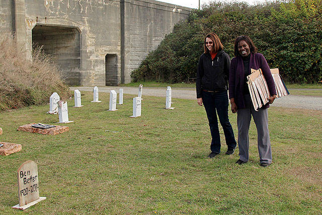 Sharon Young-Hale and Allenda Jenkins laugh as they read the humorous names featured in the cemetery, such as Ben Better, U.R Next, M.T Tomb, May B. Not and Asher T. Asher.