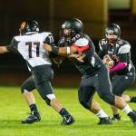 Andrew Martin (42) looks for some running room as Ryan Labrador (70) blocks the Tigers Samuel Morrison.(Photo by John Fisken)