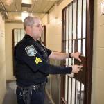 Photo by Jessie Stensland / Whidbey News-Times                                <em>Brian Braunstein, the jail sergeant in Oak Harbor, unlocks a door of the city jail, which is the smallest in the state.</em>