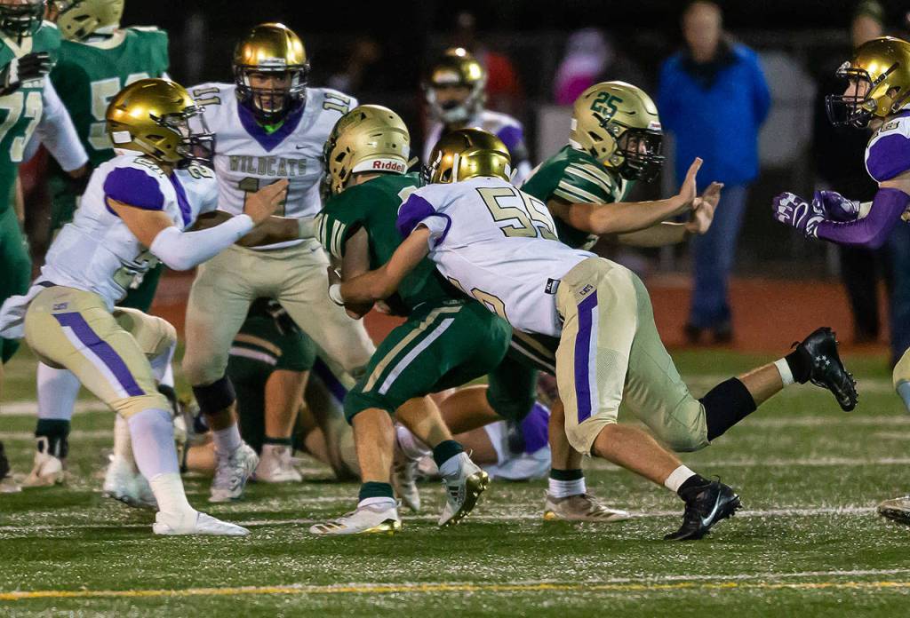 Ethan Pace (55) brings down a Timberline ball carrier.(Photo by John Fisken)