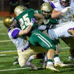 Gabriel Daggett (28) wrestlers Timberlines Jaden Gorman (25) to the ground.(Photo by John Fisken)