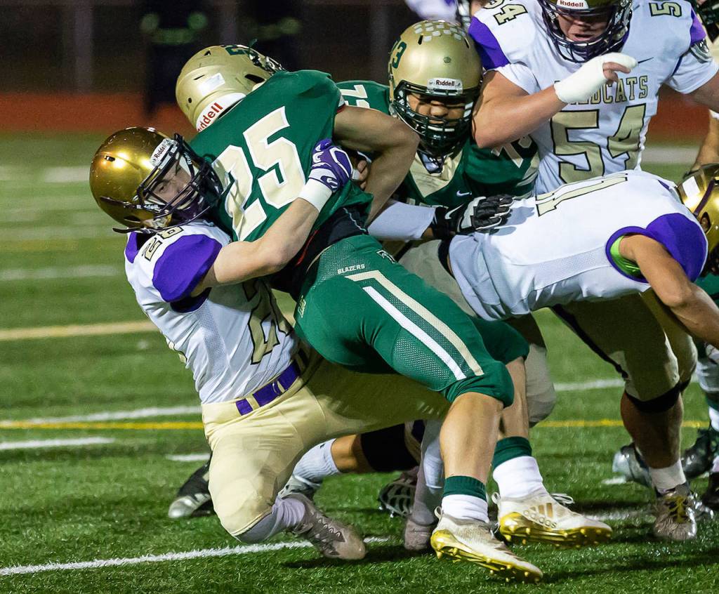 Gabriel Daggett (28) wrestlers Timberlines Jaden Gorman (25) to the ground.(Photo by John Fisken)